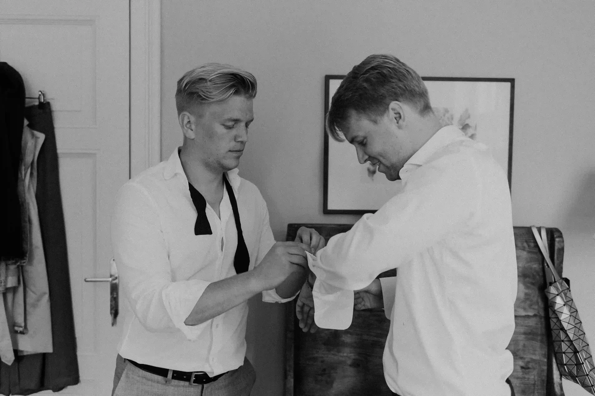 Groom getting dressed before the wedding