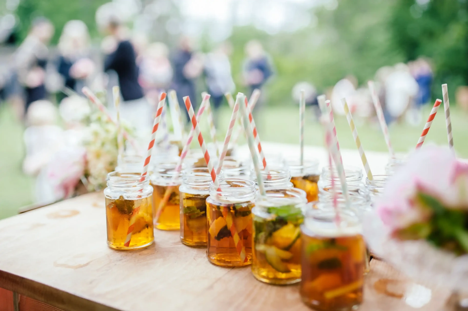 Bottles of drinks arranged on a table outdoors