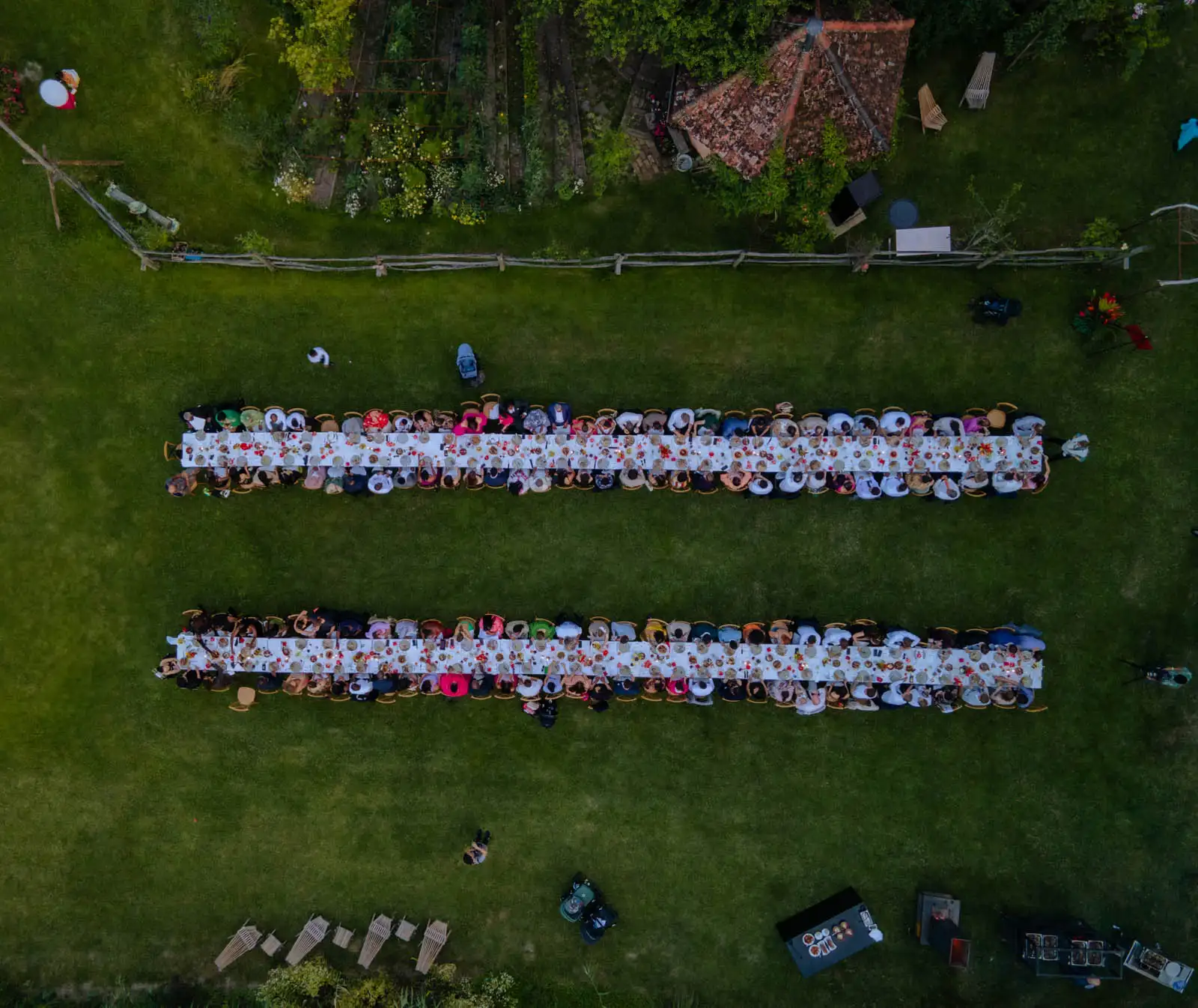 Aerial view of two long wedding tables arranged in a meadow