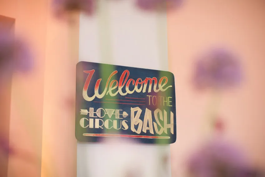 Sign reading “Welcome to the Love Circus BASH” against a softly blurred background