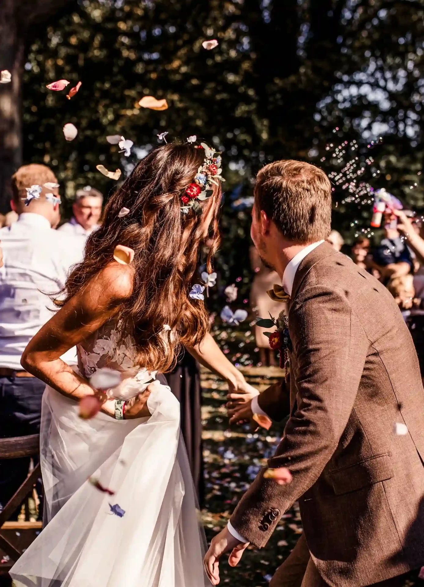 Bride and groom kissing among their guests