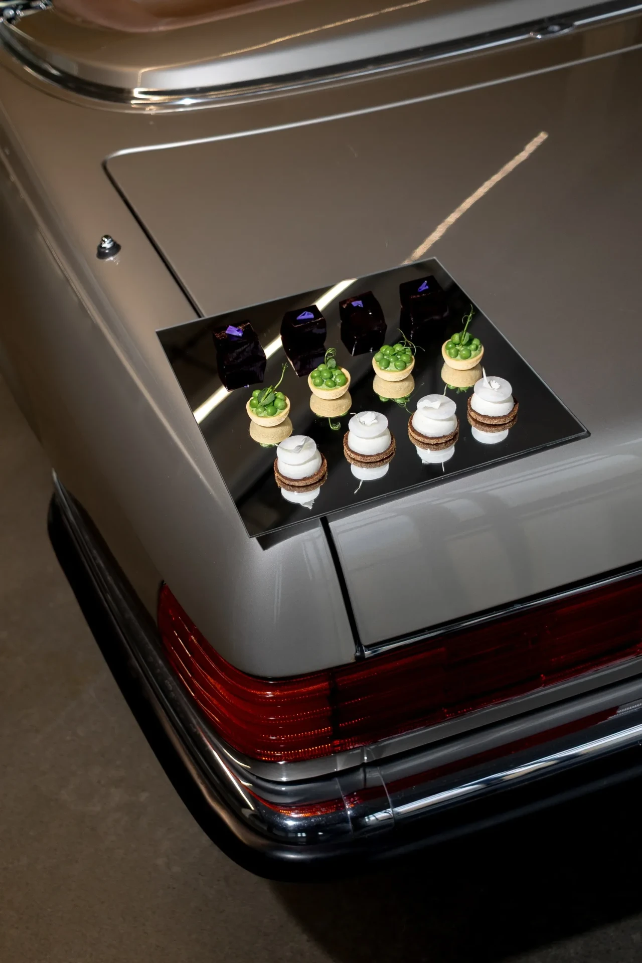 Champagne bottles on the back of a vintage car