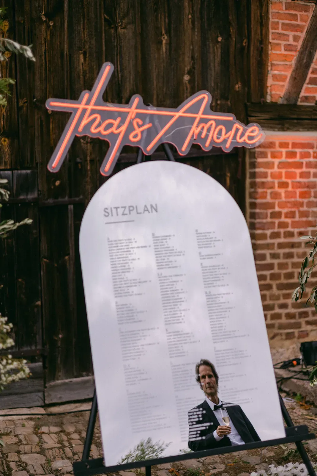 Wedding welcome sign in front of a brick wall