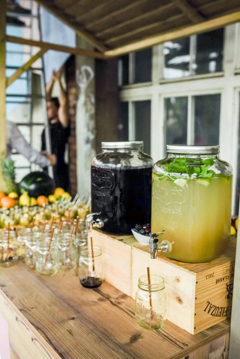 Drink station with glasses and carafes in a bright venue