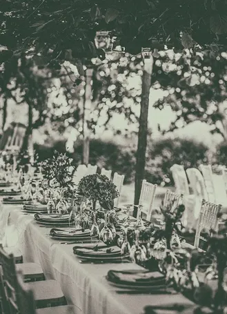 Black-and-white photograph of a long outdoor wedding table