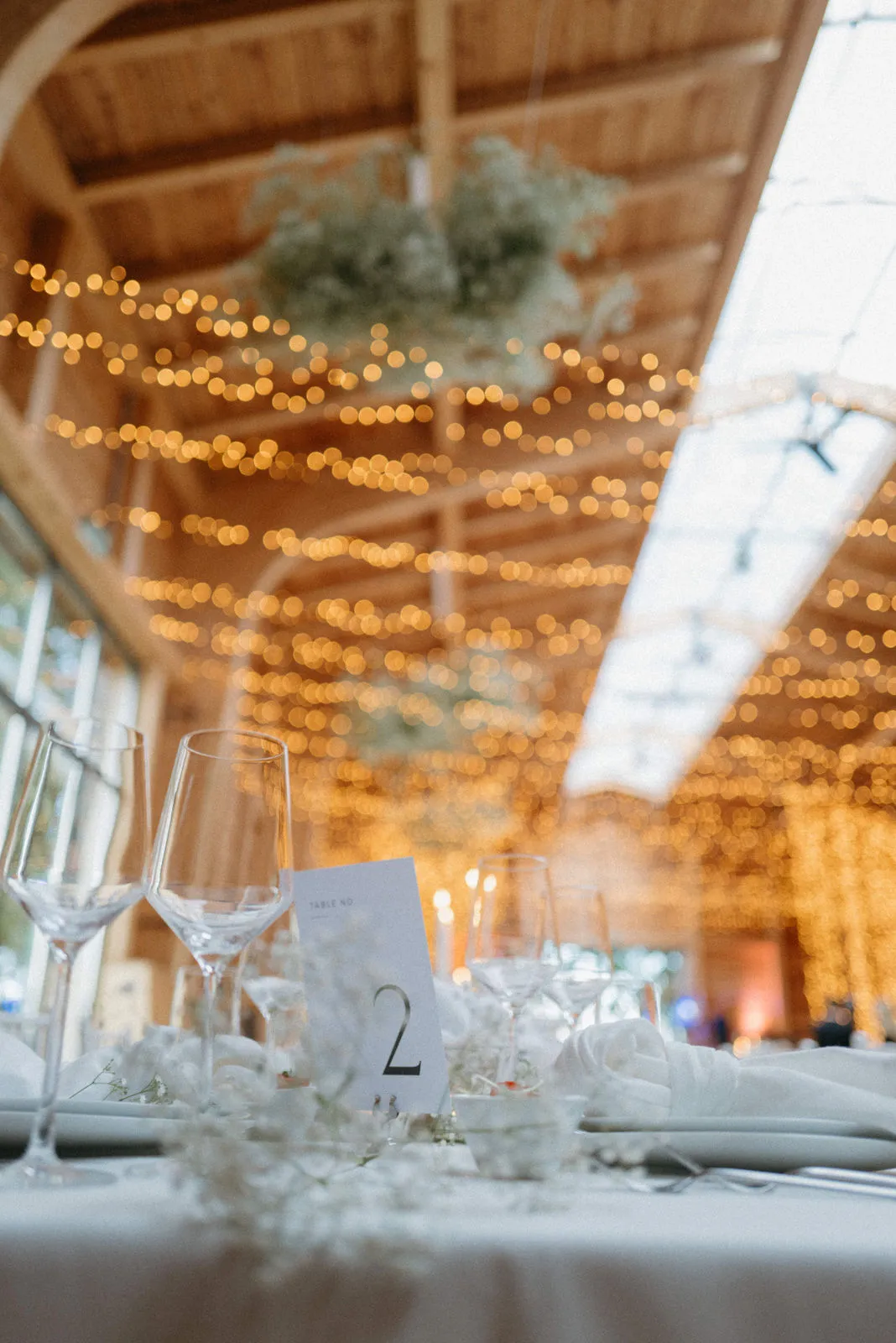 Floral arrangement on a narrow table in front of a window
