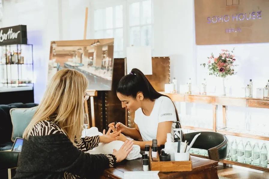 Two women seated at a table talking