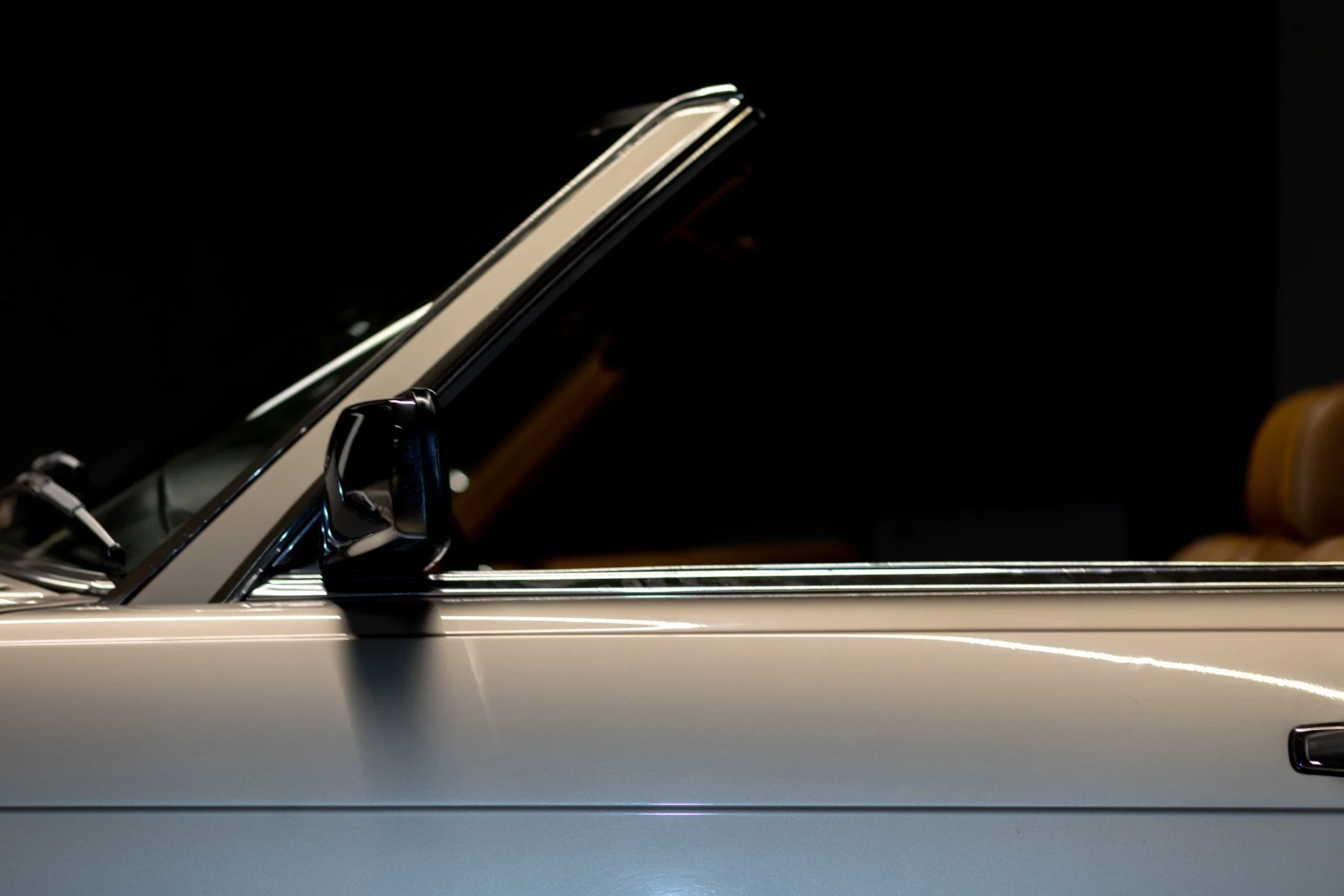 Bride reclining in a convertible with the top down