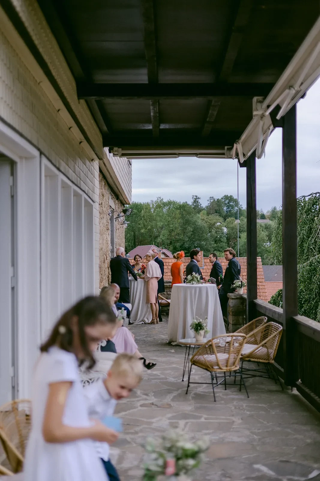 Guests seated on a covered terrace during the wedding celebration