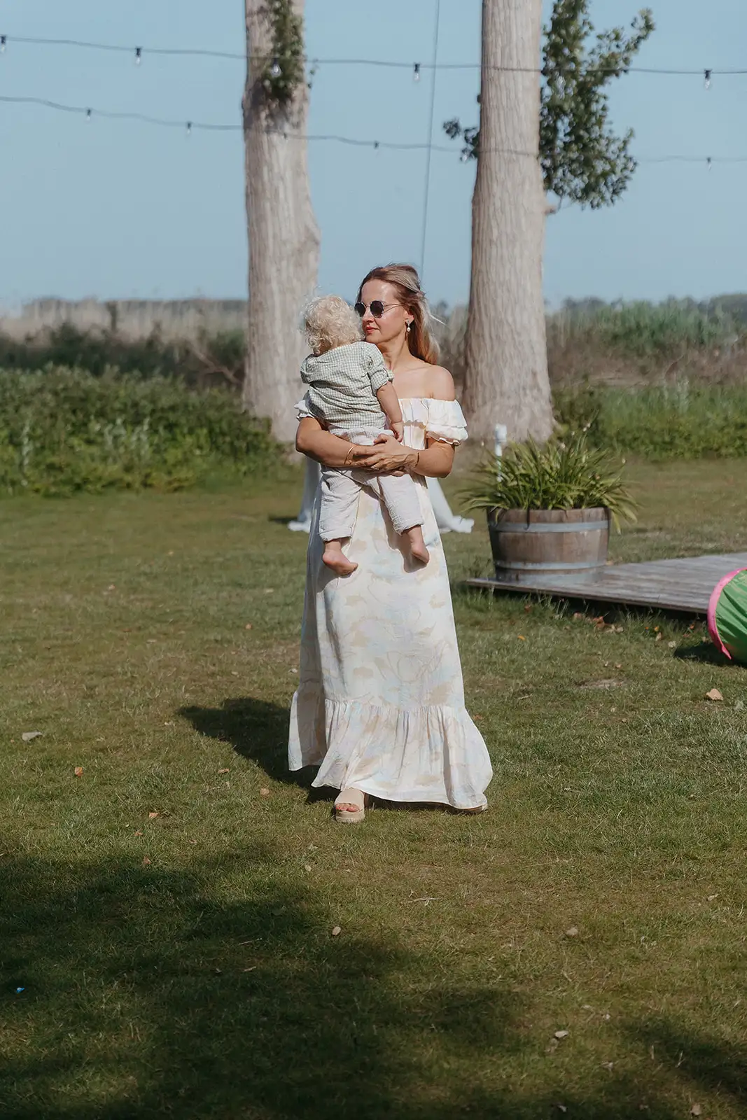Bride standing alone outdoors in her wedding dress