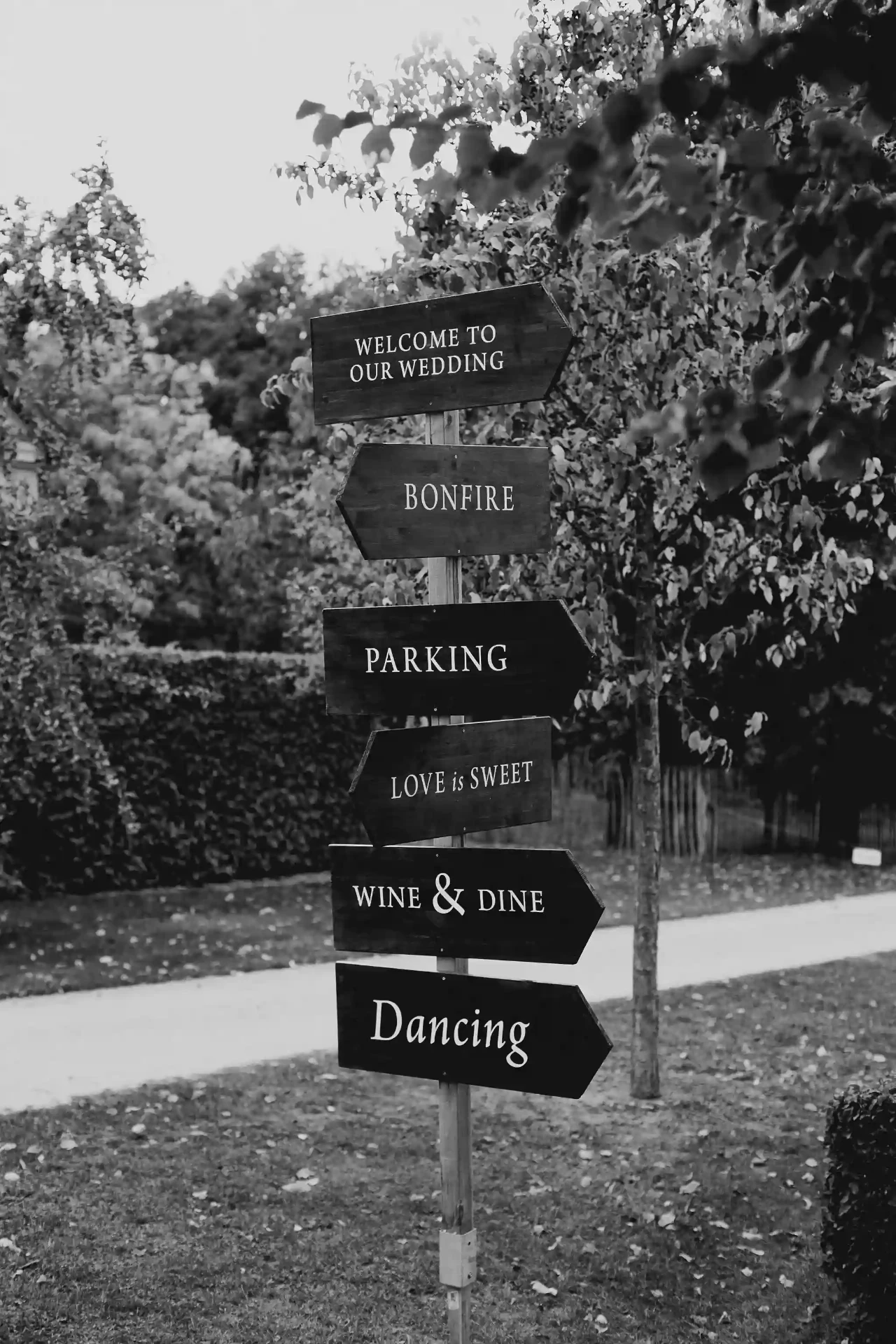 Simple wooden direction signs at a wedding
