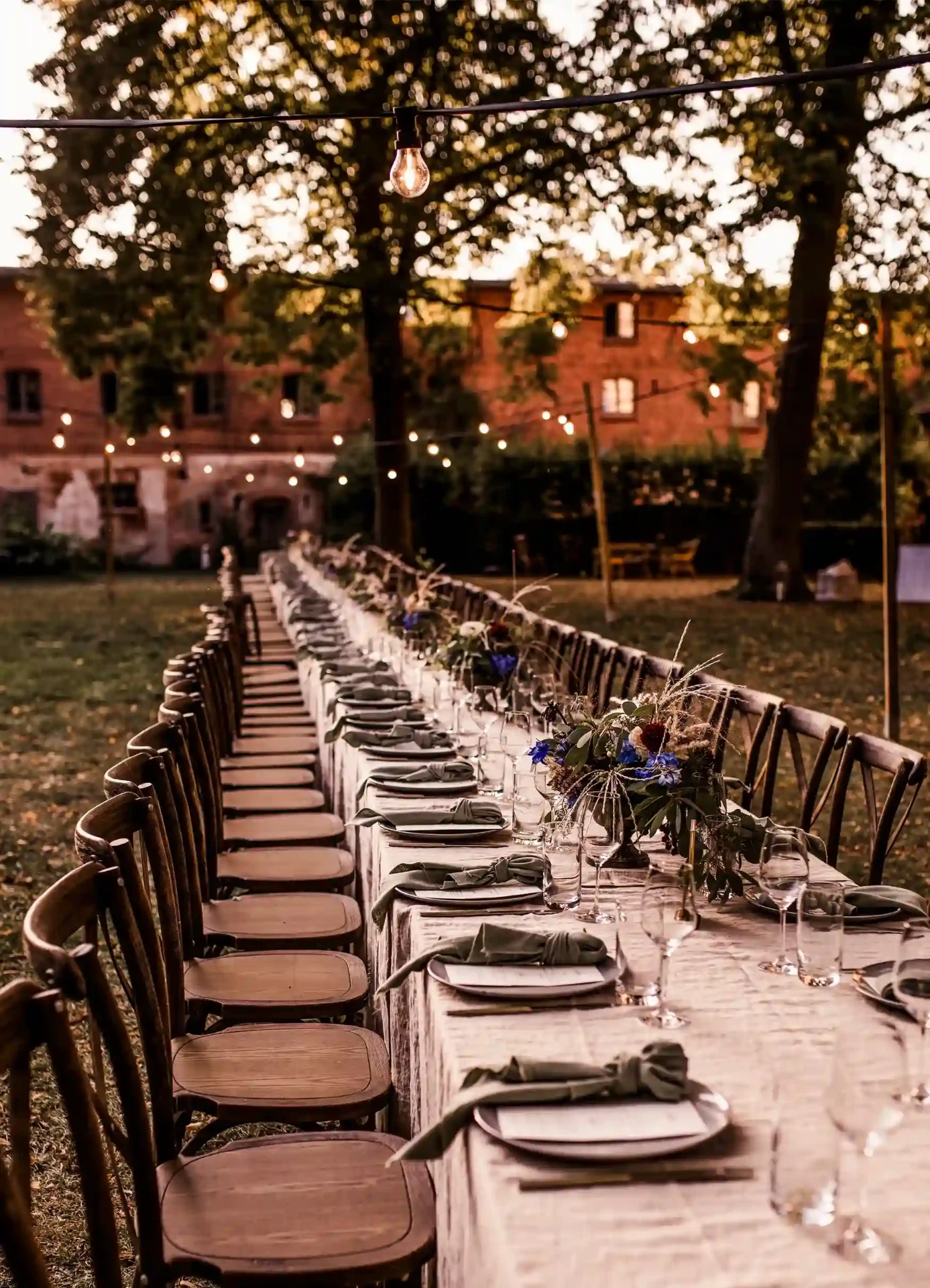 Guests seated at a long outdoor wedding table