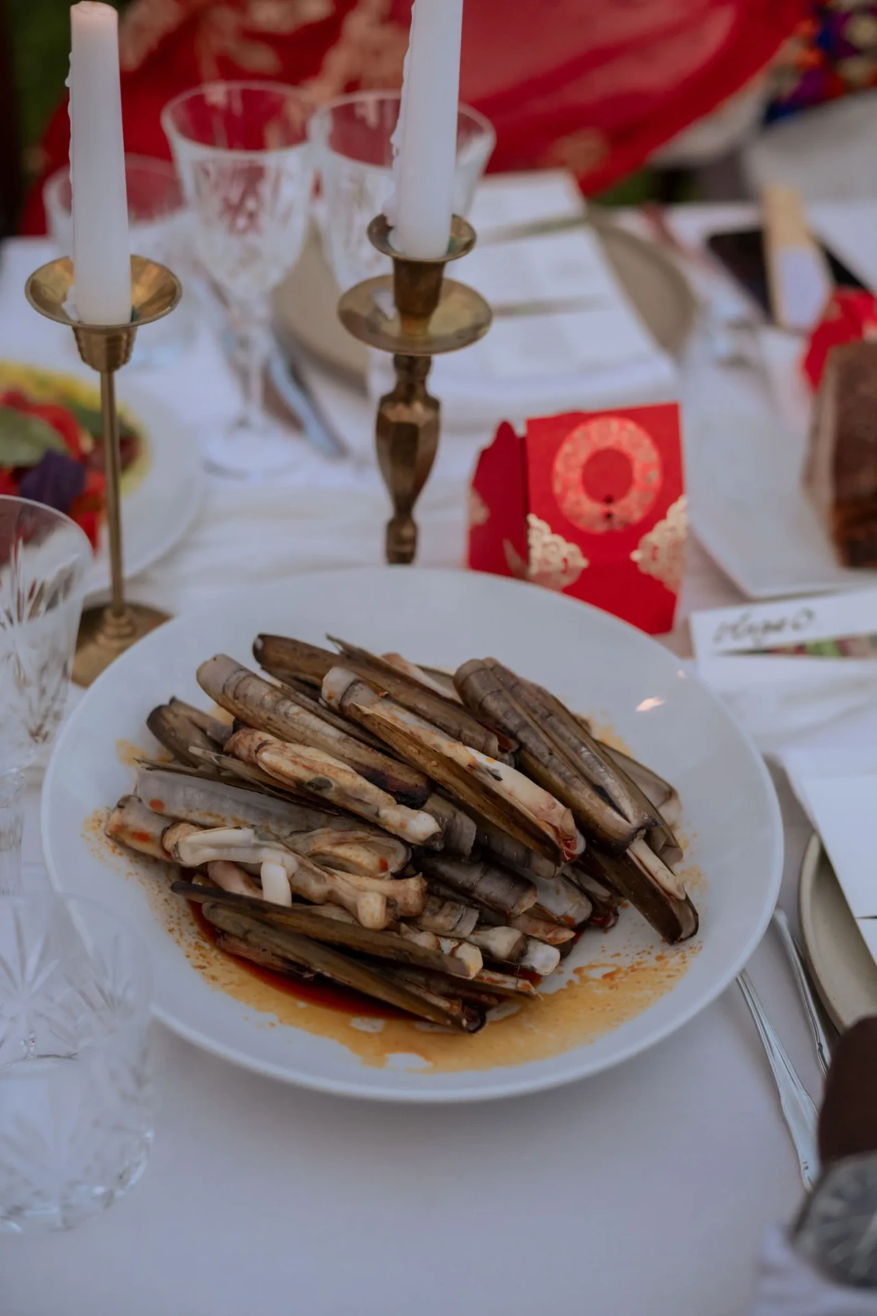 Plate of grilled food on a formally set dining table