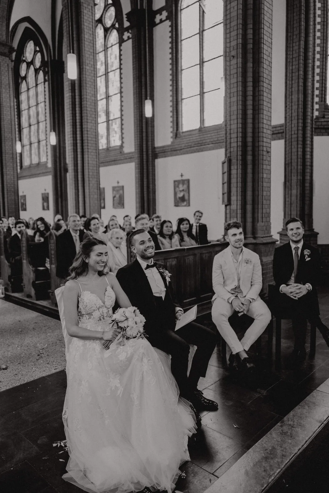 Wedding guests gathered for a group photo inside a church