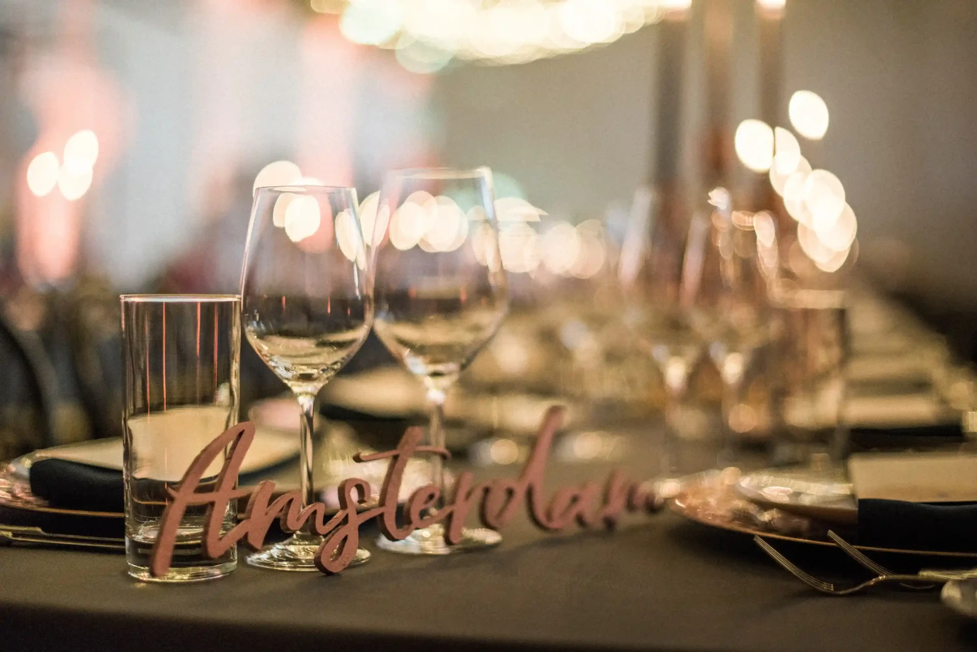 Wedding table set with glasses, candles and table decor