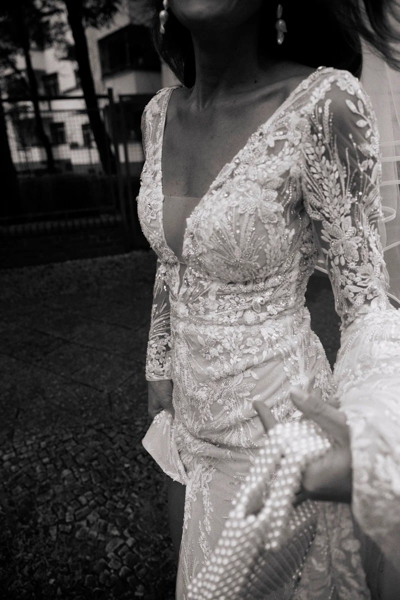 Detail of the bride’s embroidered dress, black-and-white photograph