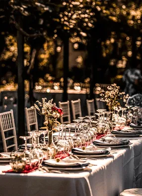 Long wedding table beneath trees at night