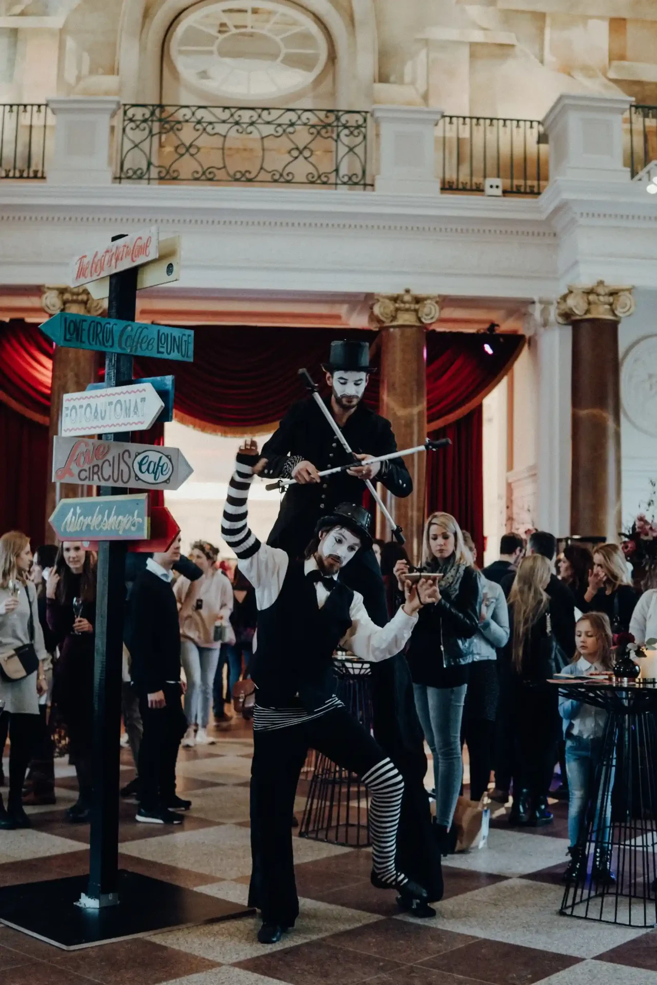 Visitors in an exhibition space with a high ceiling