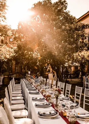 Long outdoor wedding table in warm evening light