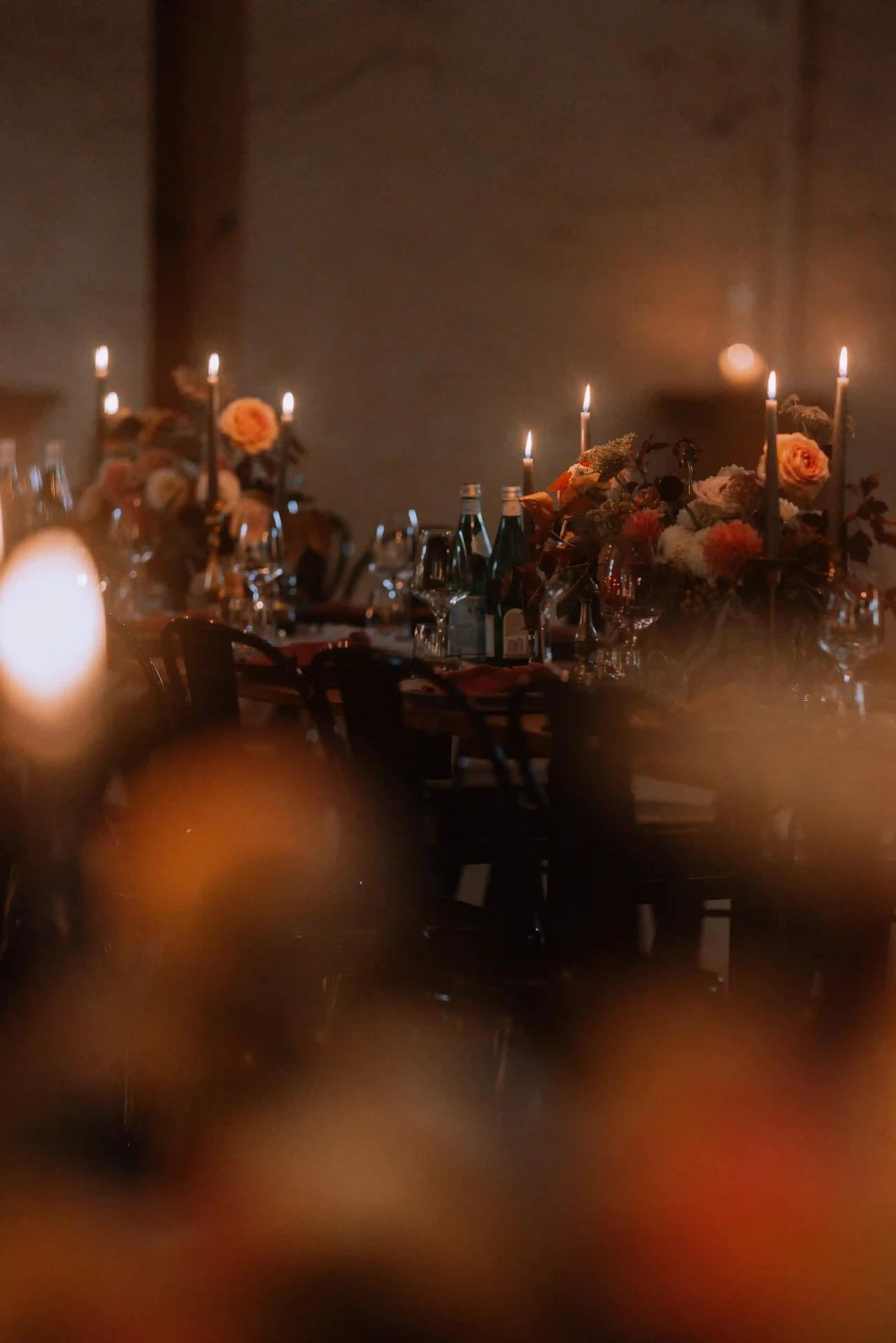 Guests seated at a long table in a rustic hall
