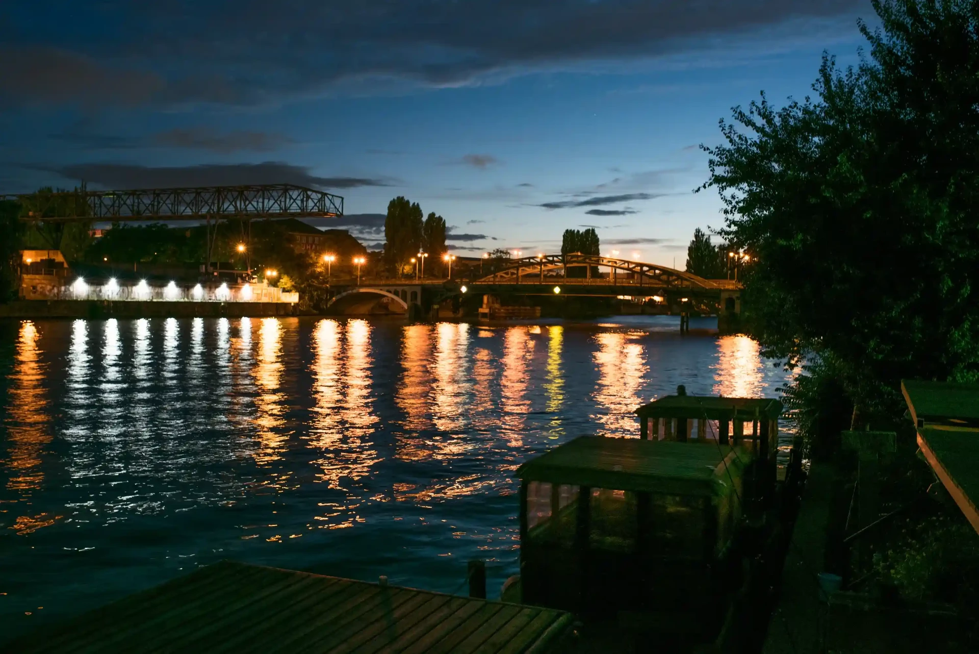 Spree riverbank at night with lights reflected in the water