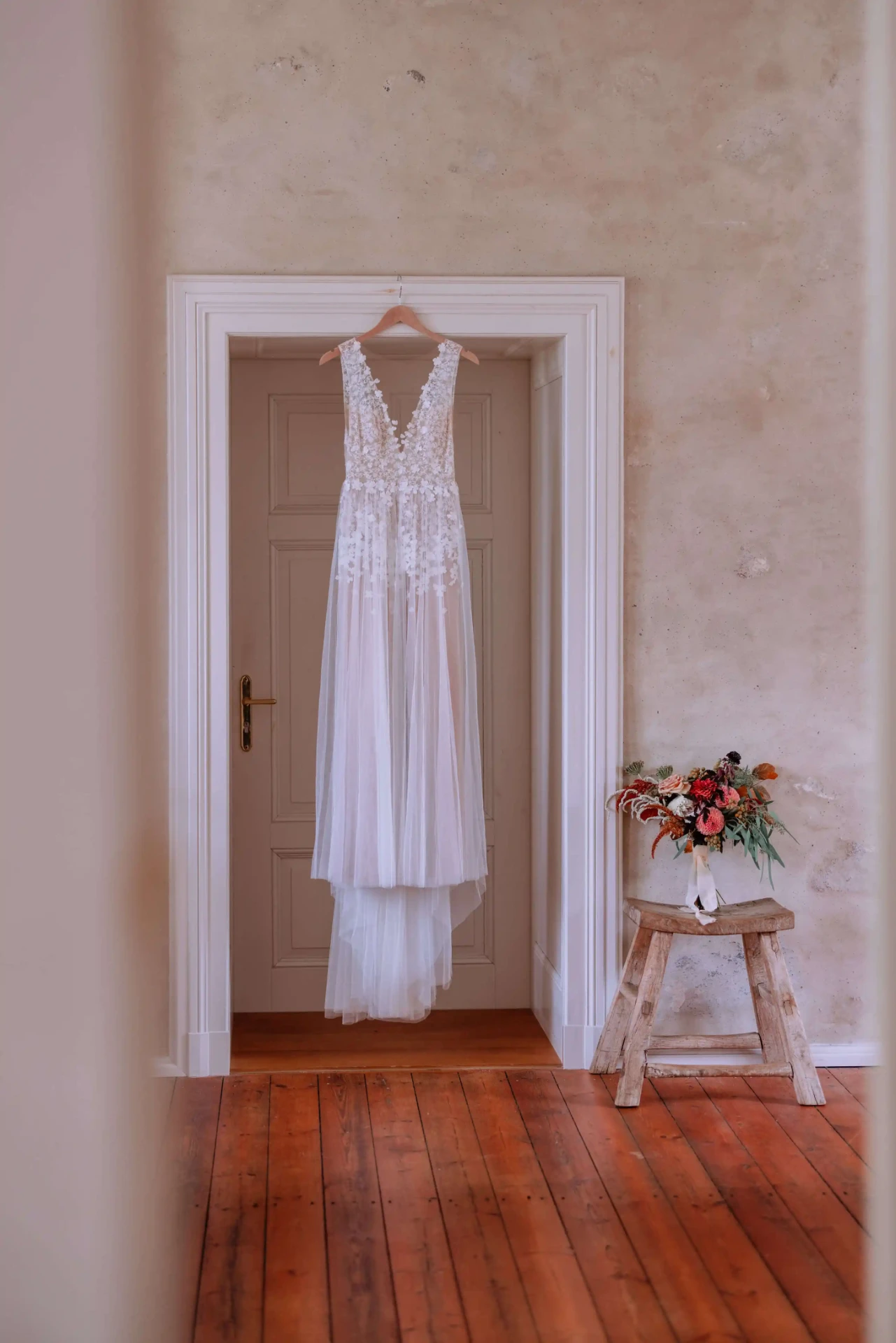 Wedding dress hanging in a tall window