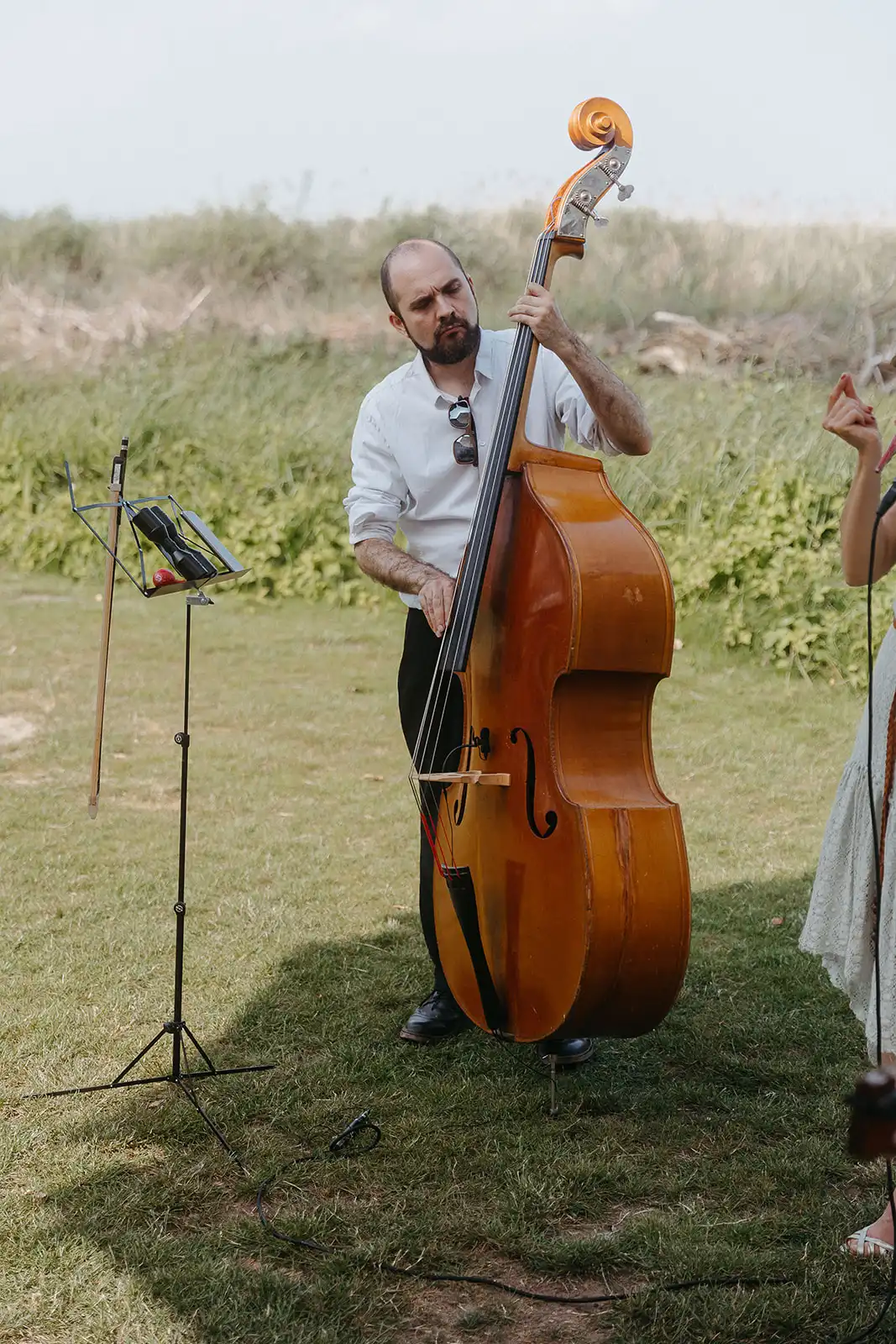 Musician playing double bass outdoors