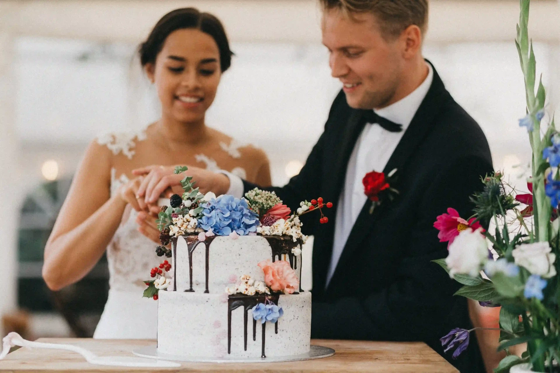 Bride holding her bouquet beside the groom