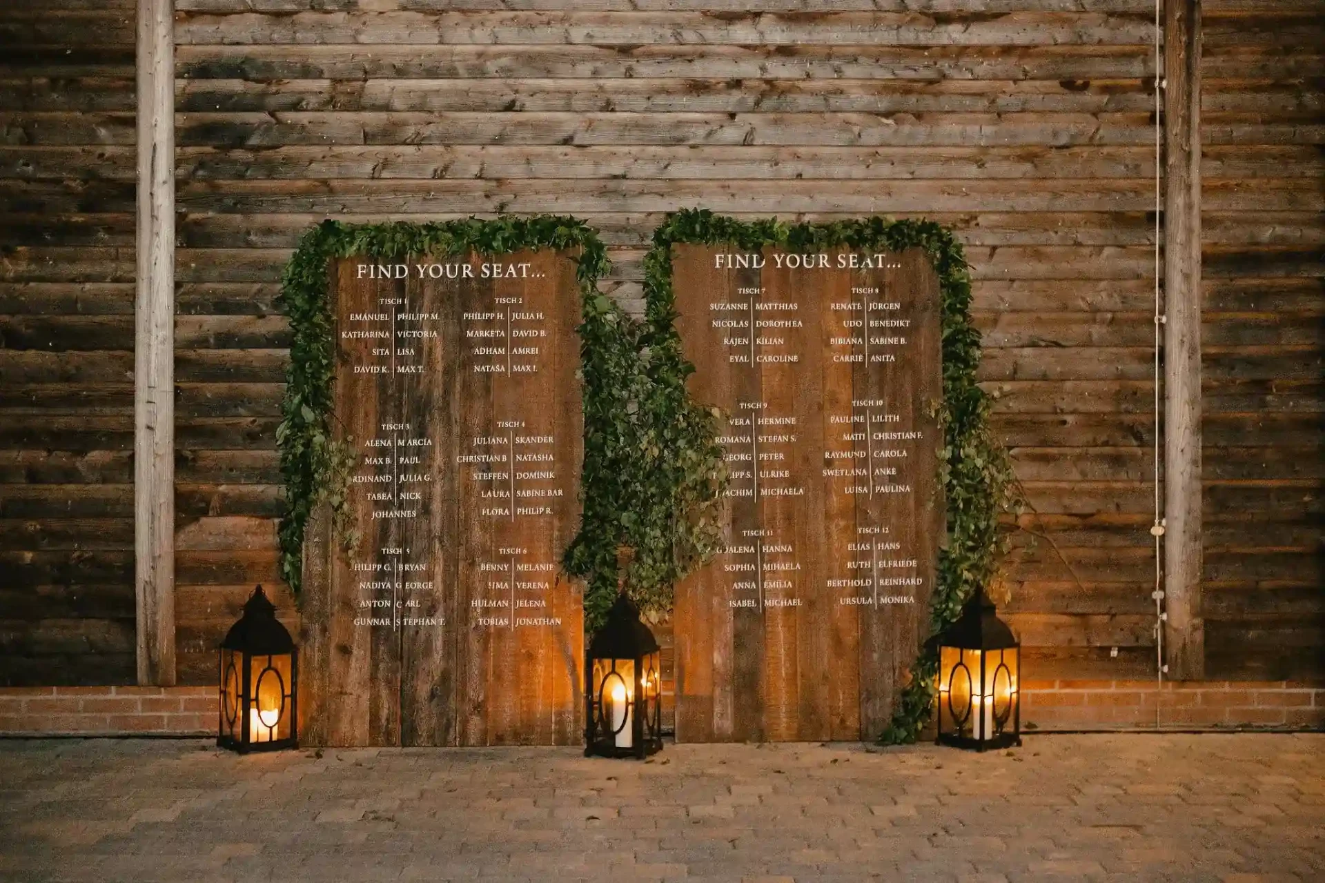 Wedding backdrop with candles and flowers in front of a brick wall