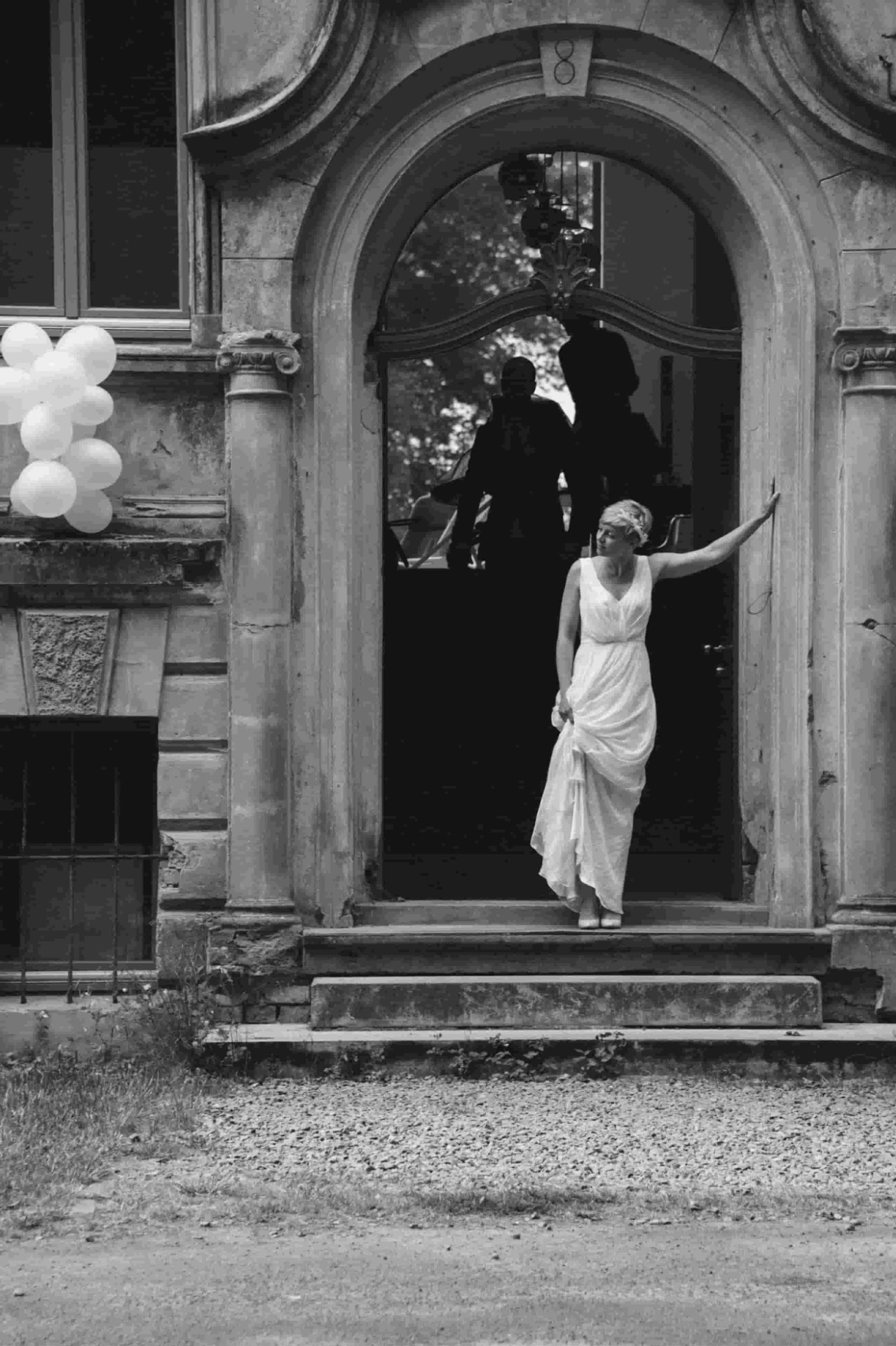 Bride standing in the entrance of a historic building