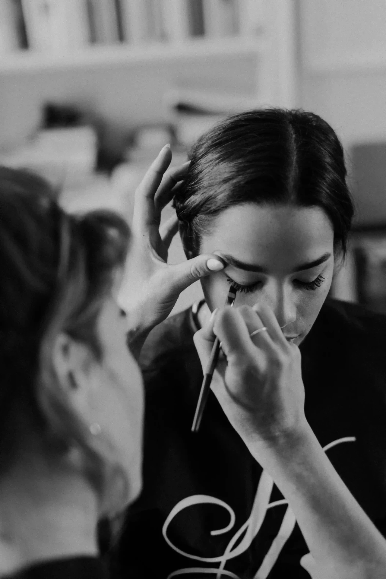 Bride being helped while getting ready