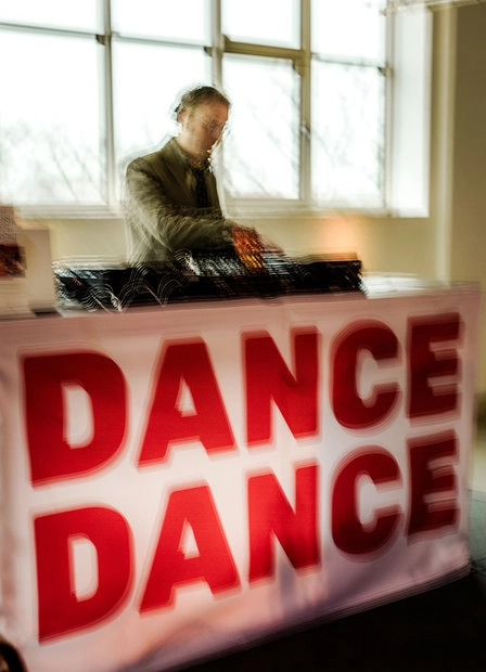 Red sign reading “DANCE DANCE”
