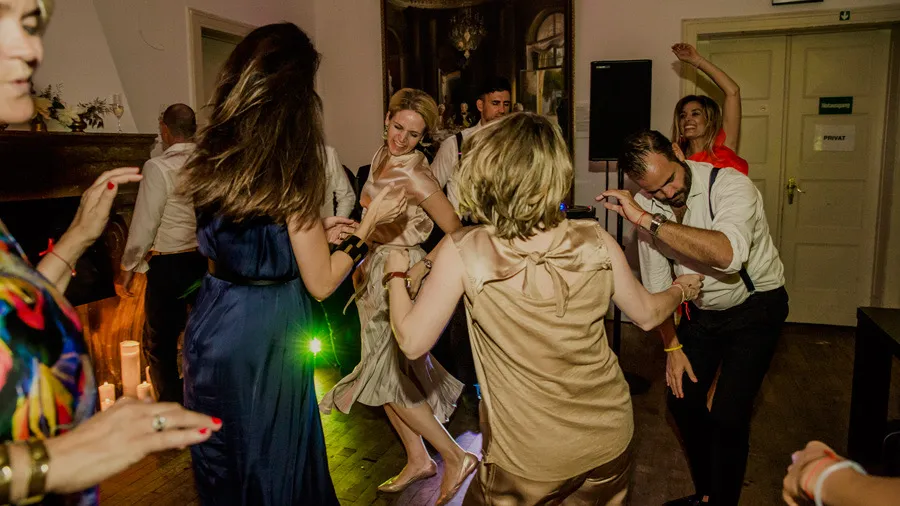 Guests dancing exuberantly at the wedding reception