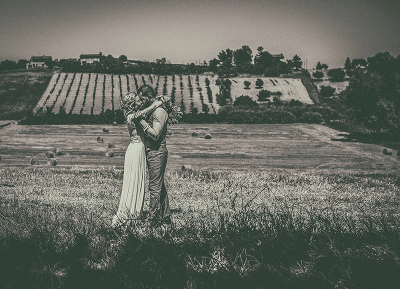Wedding couple embracing in a vineyard landscape in Piedmont, black-and-white photograph