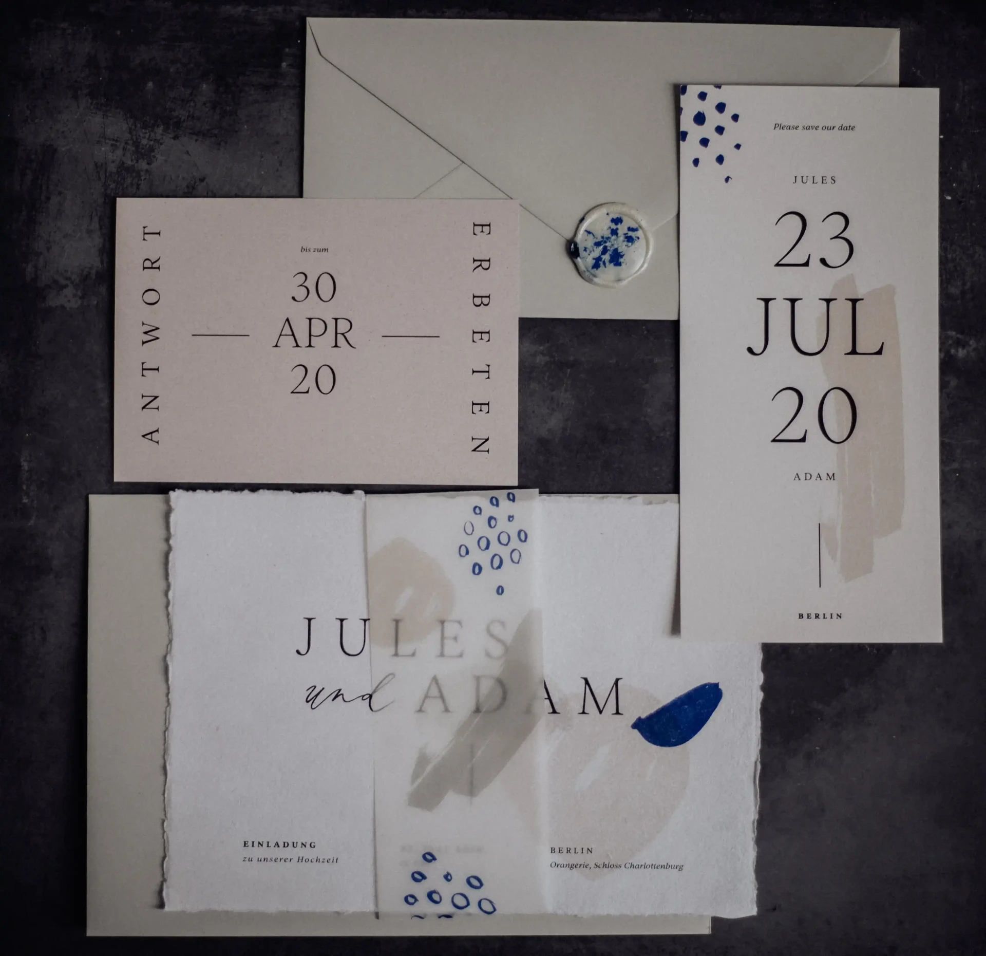 Wedding stationery with blue lettering and a date on light paper