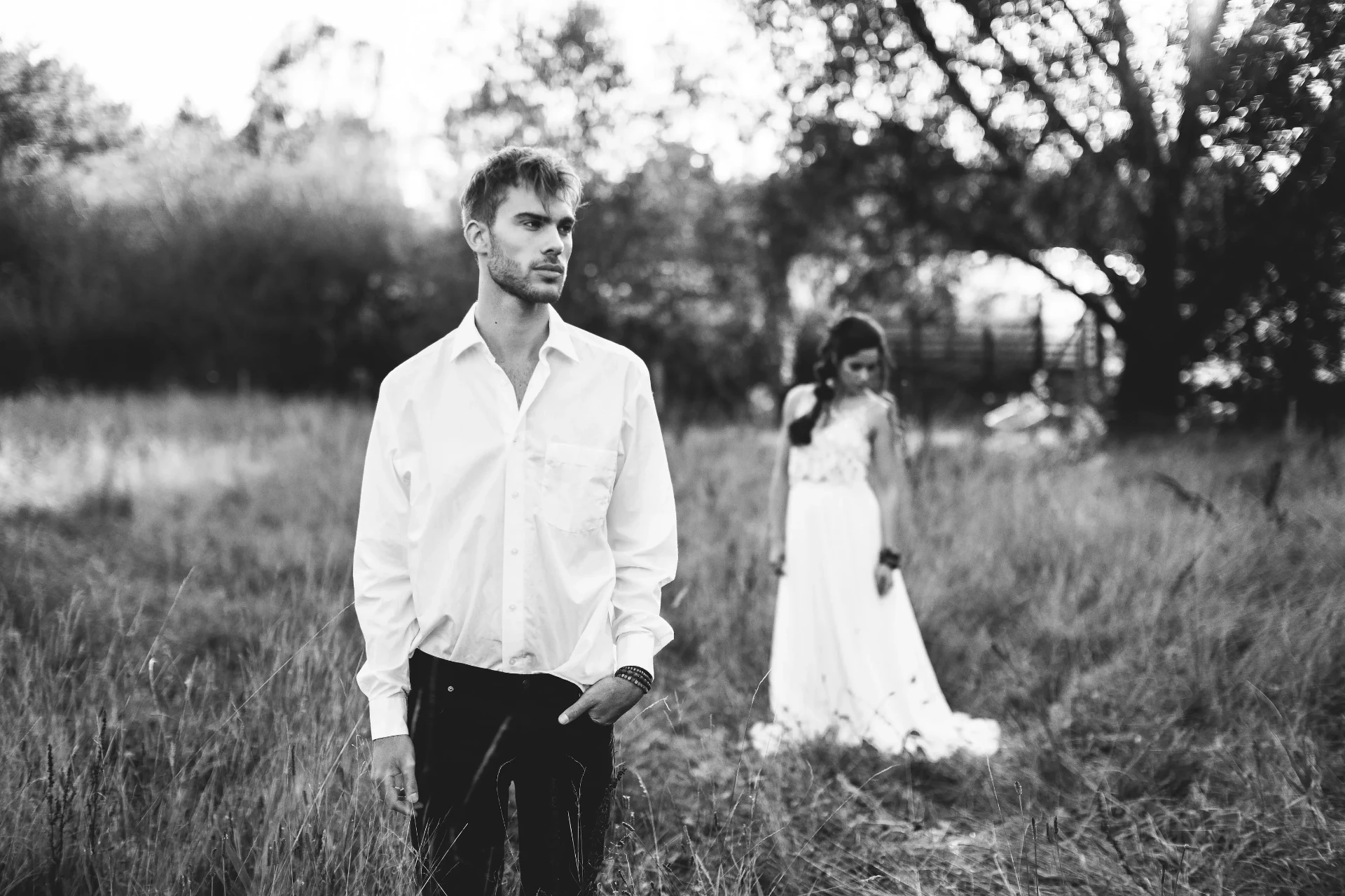 Bride and groom kissing in a meadow in warm evening light