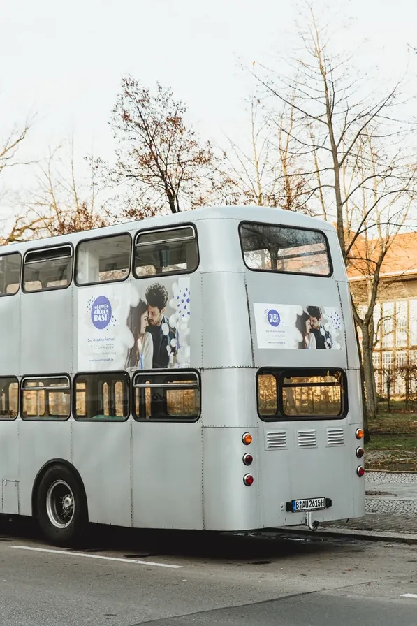 White double-decker bus on a street