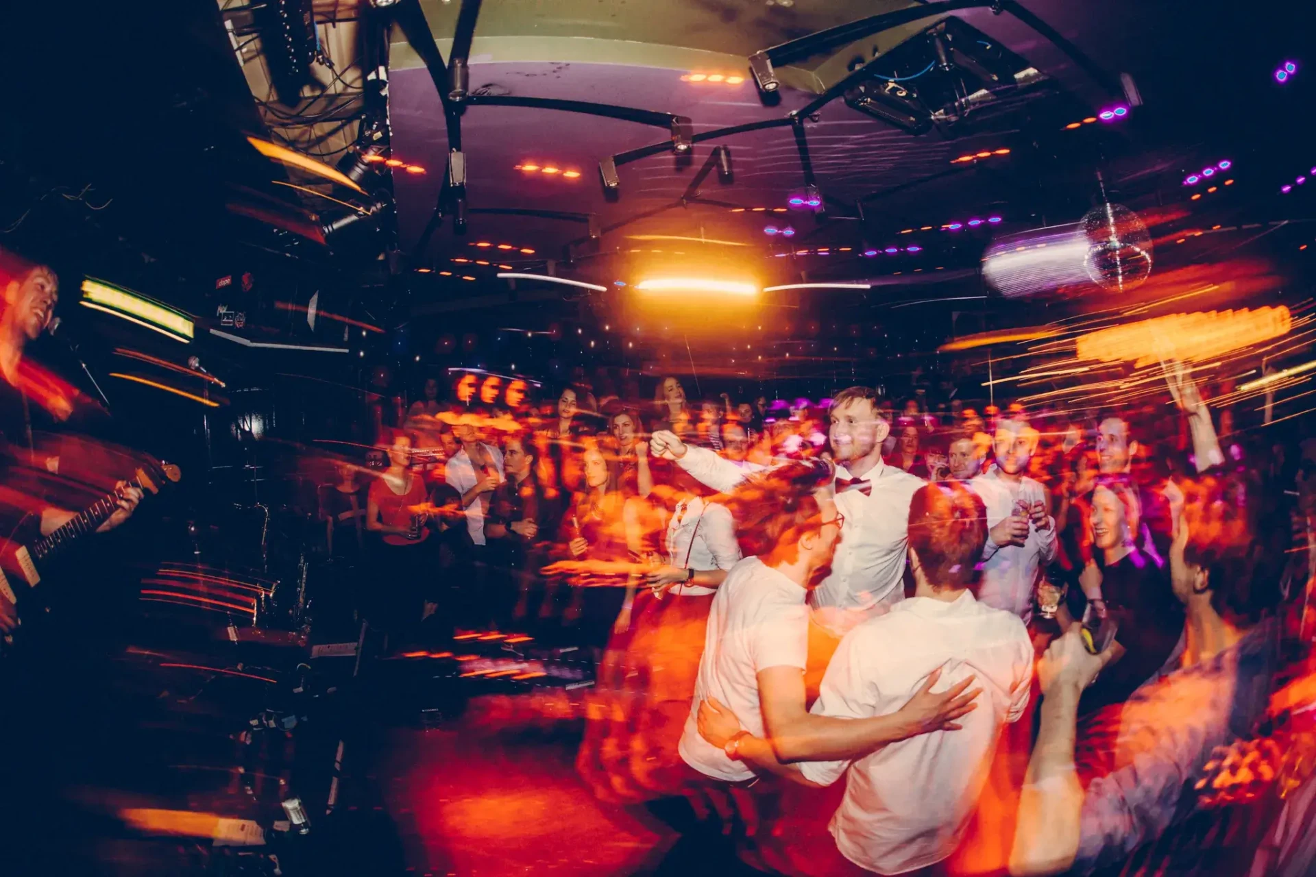 Guests partying on the dance floor under colourful lights