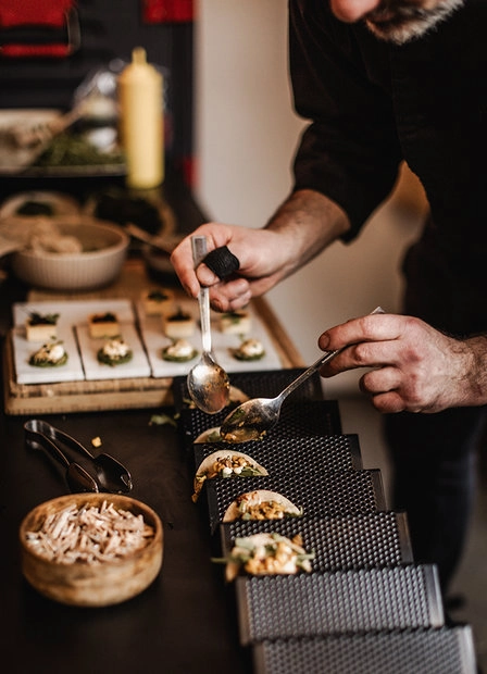 Small dishes being arranged on a tray