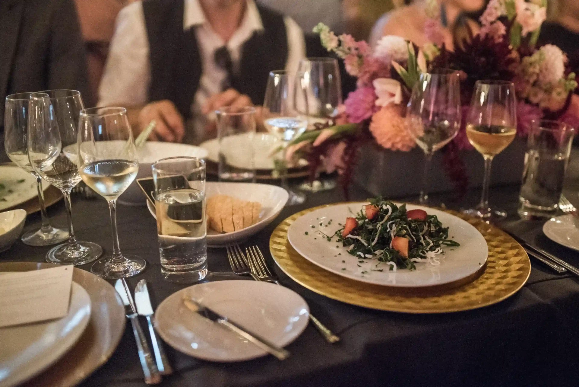 Guests seated at a dinner around a festively set table