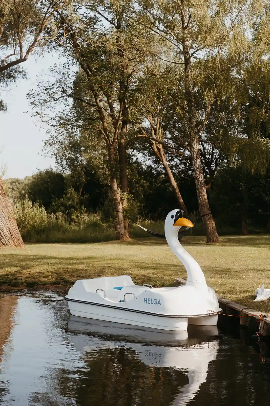 White rowboat on the water near the shore