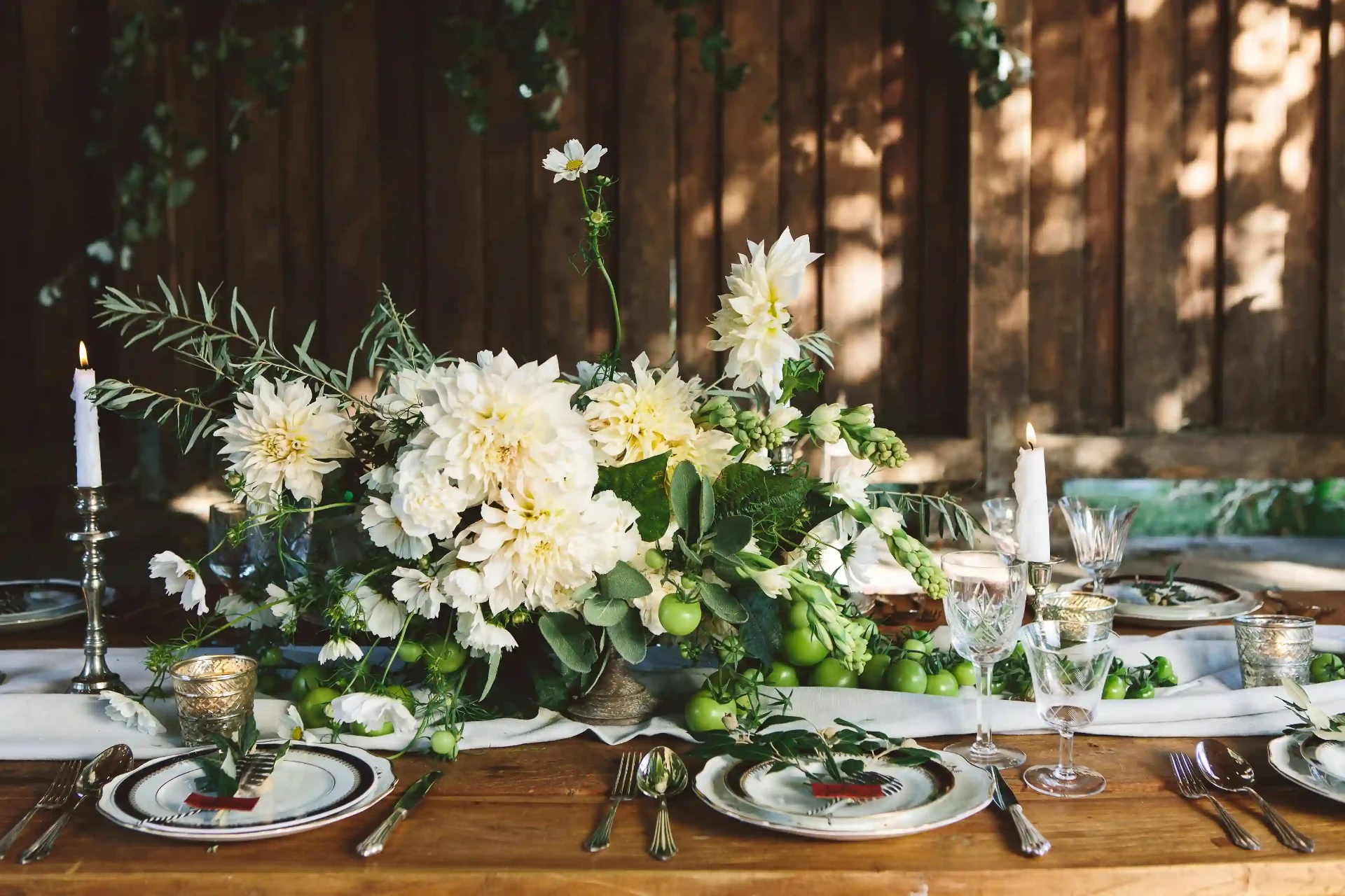Long wedding table in a rustic interior illuminated by warm candlelight