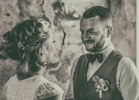Bride and groom embracing in a black-and-white photograph