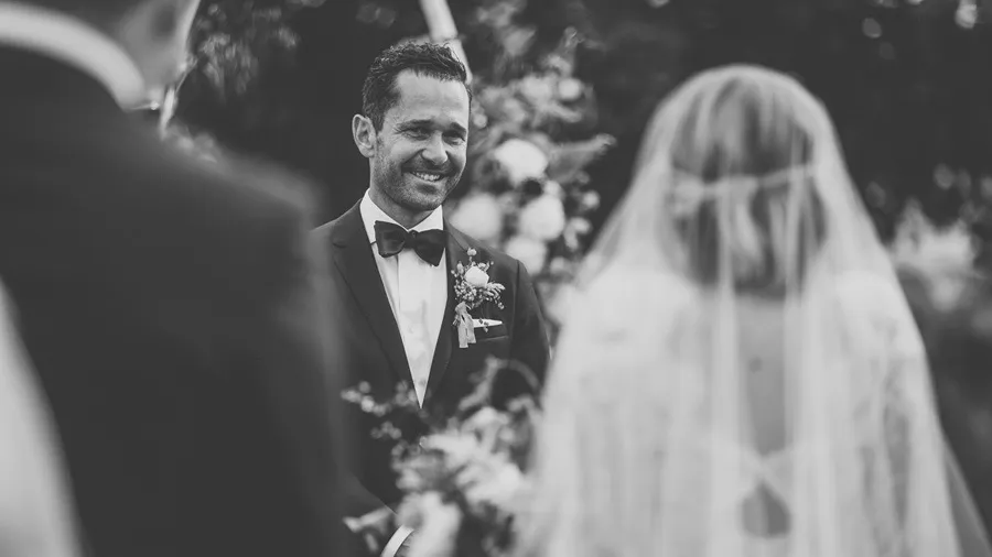 Bride and groom during their ceremony in black and white