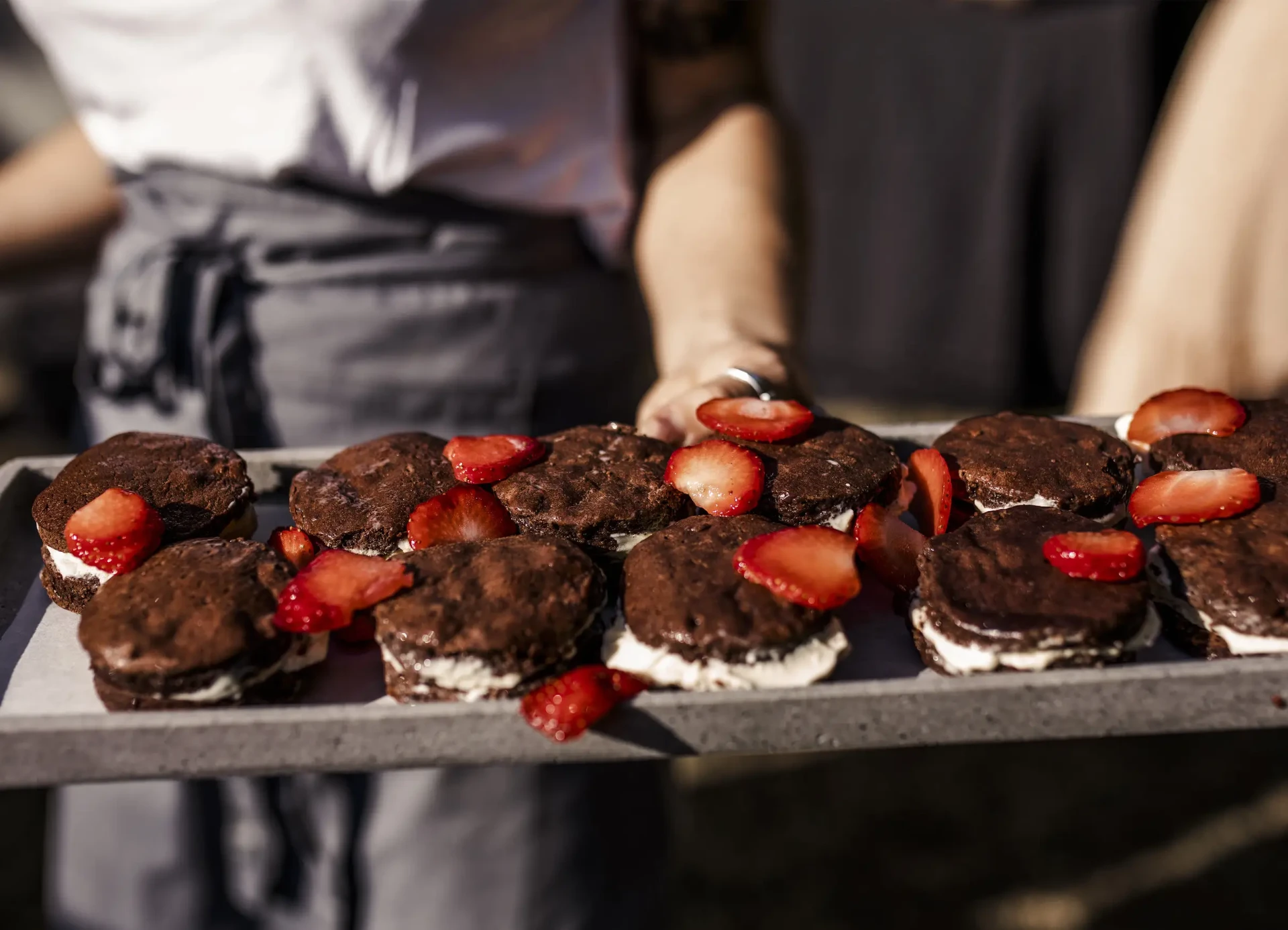 Desserts with berries and chocolate arranged on a tray