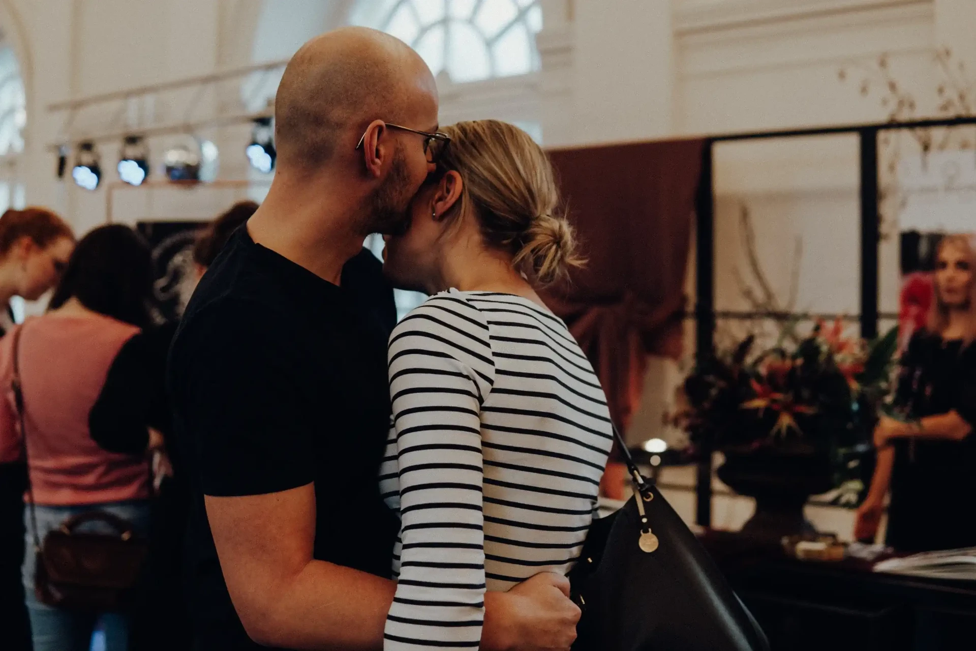 Two guests embracing at an event