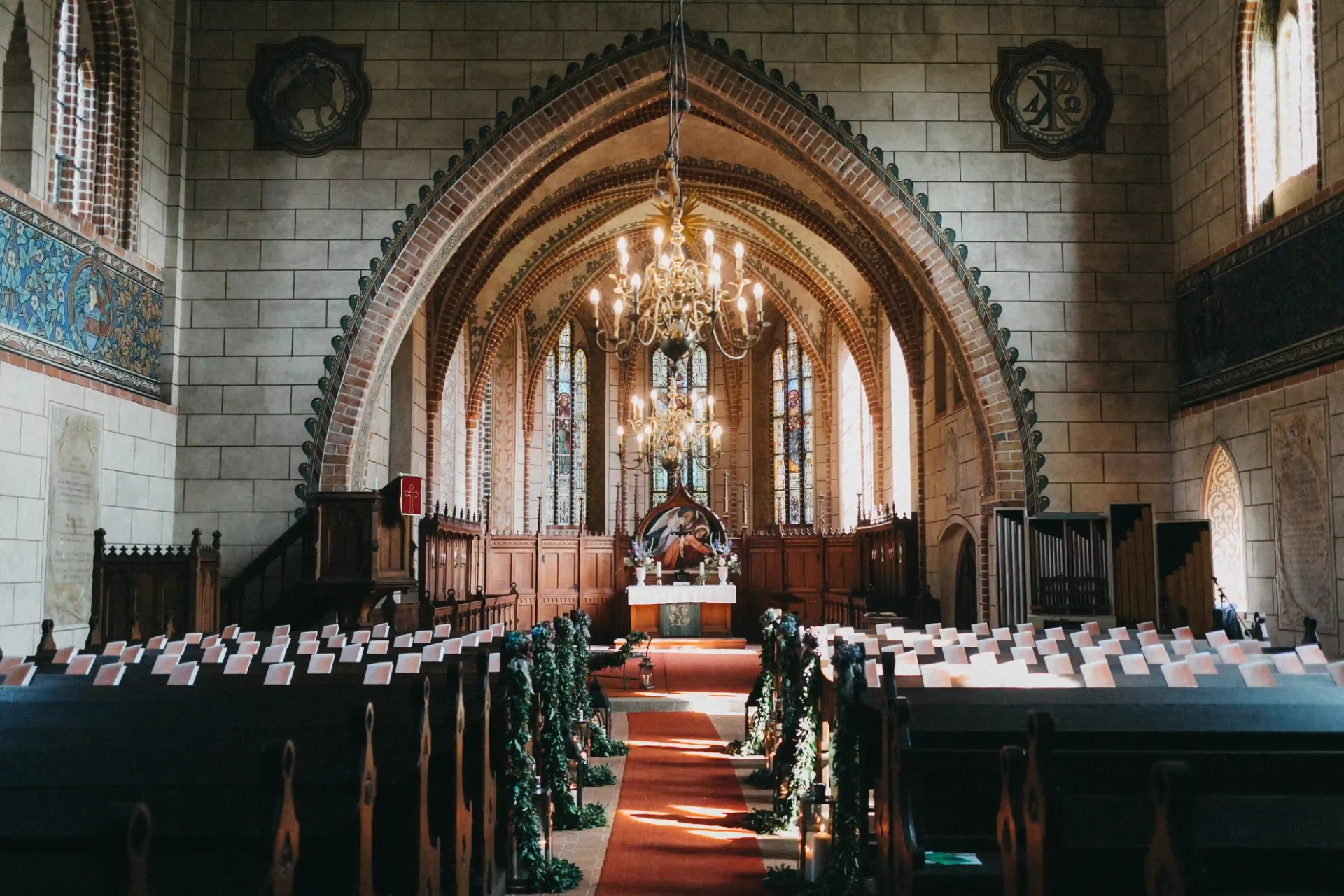 Church nave with rows of pews and floral decorations