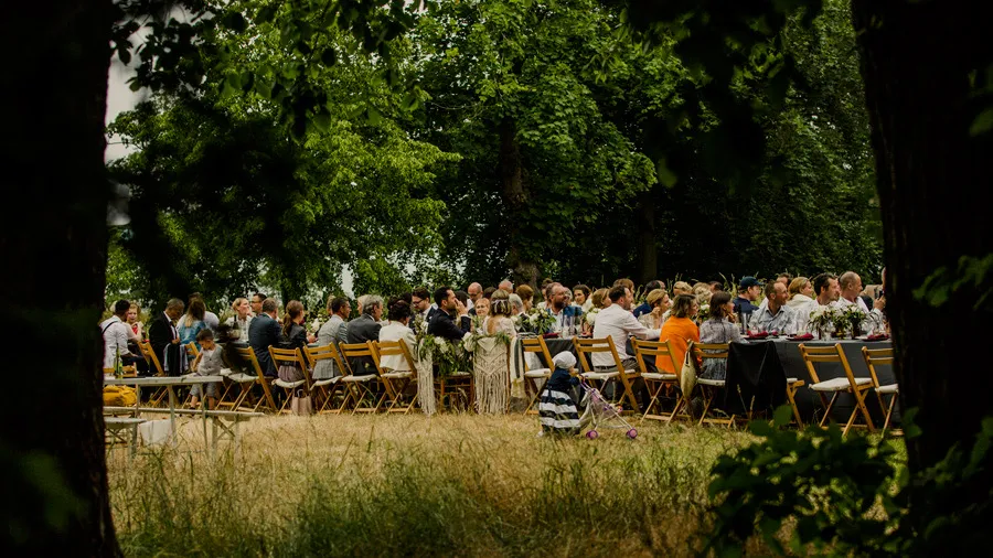 Guests seated at long tables in the garden