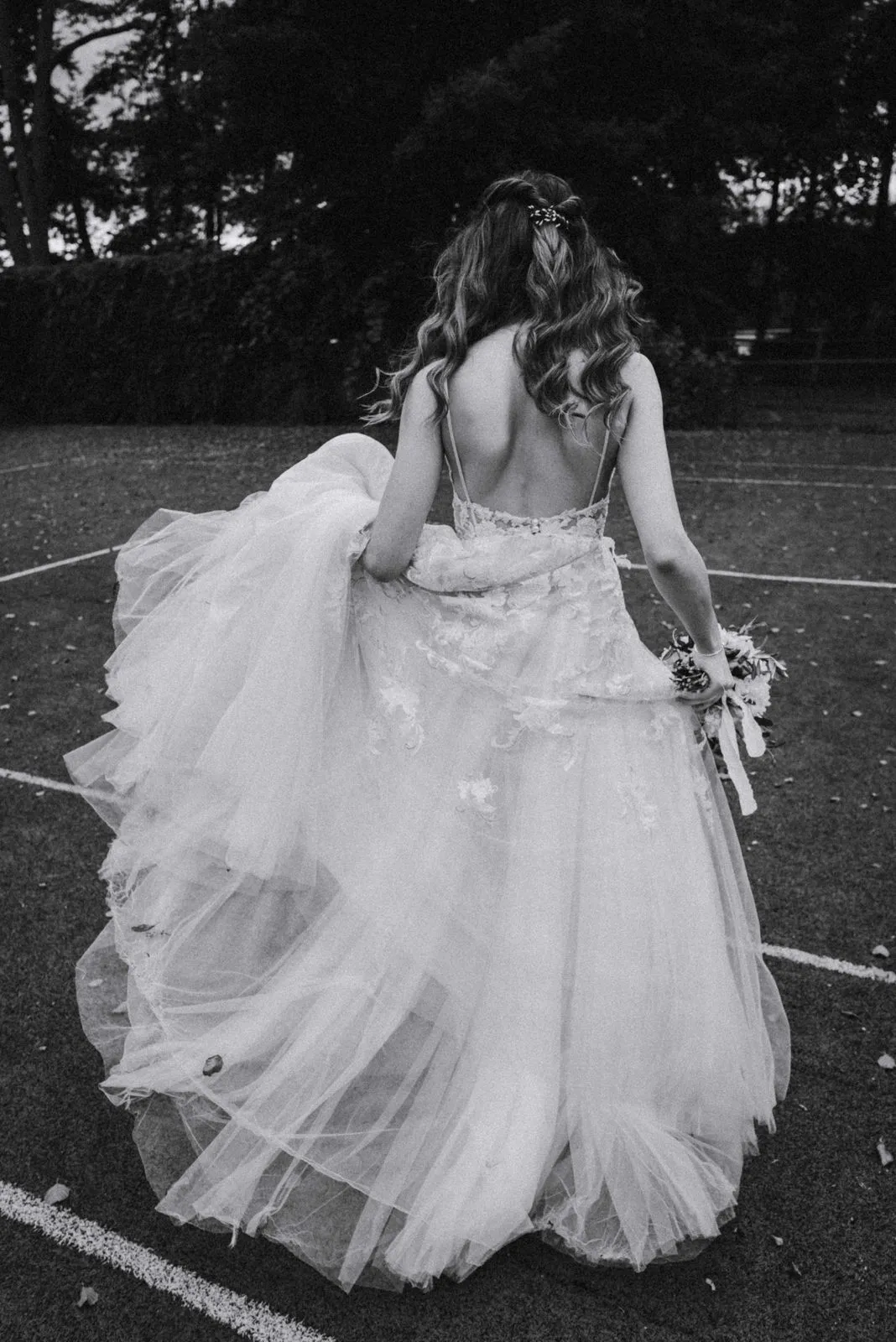 Bride and groom dancing closely together in a black-and-white photograph