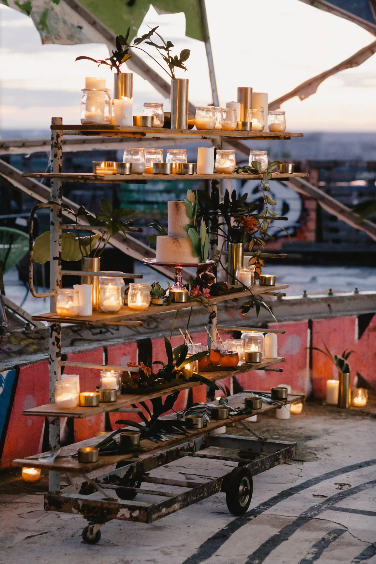 Drinks and candles on a bar trolley overlooking Berlin at sunset